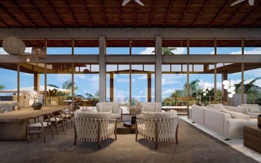 A spacious living room with large windows offers a stunning view of the ocean at Las Crestas