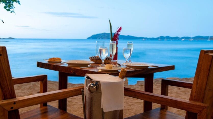 A table set with two chairs and a bottle of champagne, creating an inviting atmosphere for a celebration.