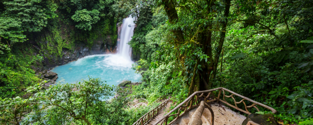 A stunning waterfall cascading through lush greenery in Costa Rica, showcasing the beauty of nature's landscape.