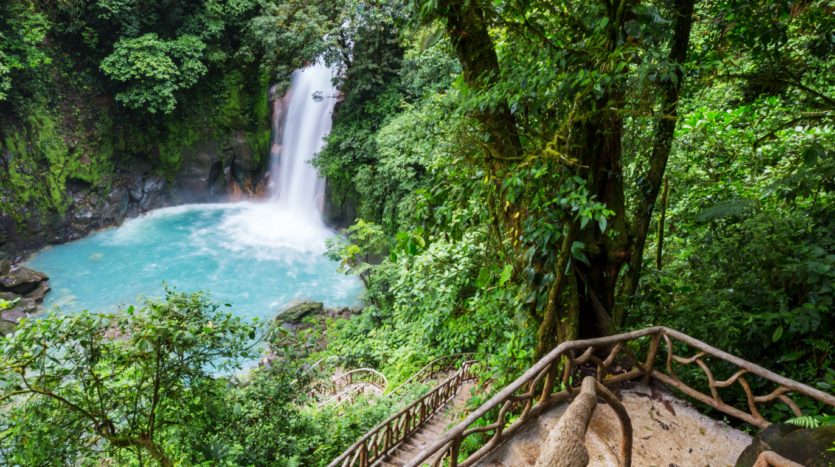 A stunning waterfall cascading through lush greenery in Costa Rica, showcasing the beauty of nature's landscape.