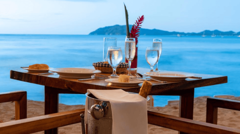 A table set with two chairs and a bottle of champagne, creating an inviting atmosphere for a celebration.