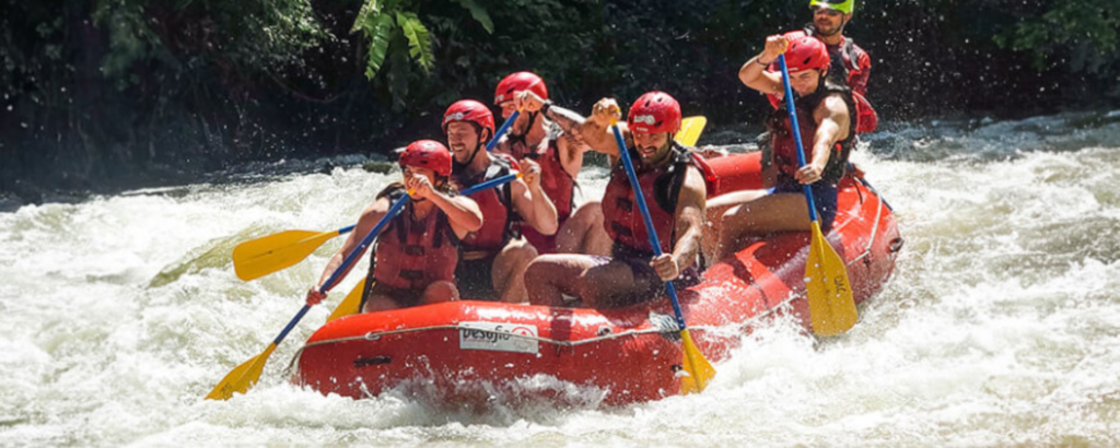 A diverse group of individuals enjoying a rafting adventure on a scenic river, surrounded by lush greenery